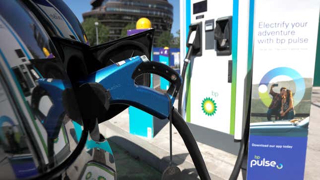 An electric powered taxi is seen being charged at a BP Pulse electric vehicle charging point in London